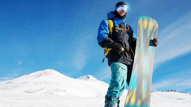 A man holding a snowboard